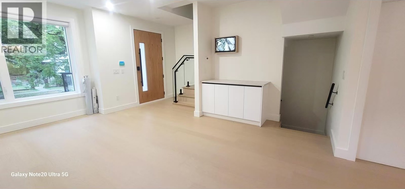 Main floor foyer with oak front door and floating stair