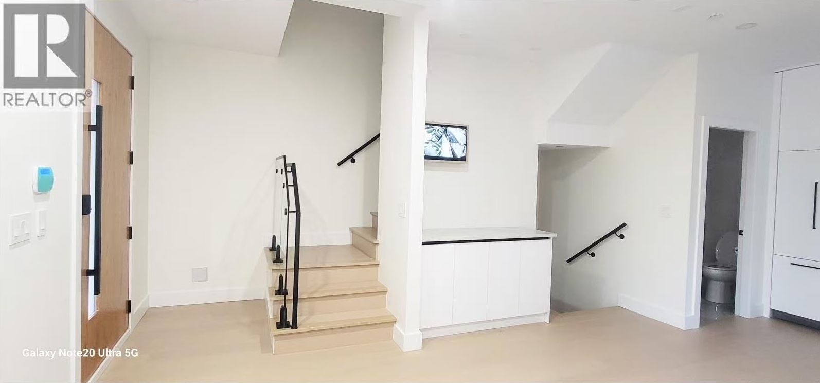 Entry with open stair, glass railing and built-in storage