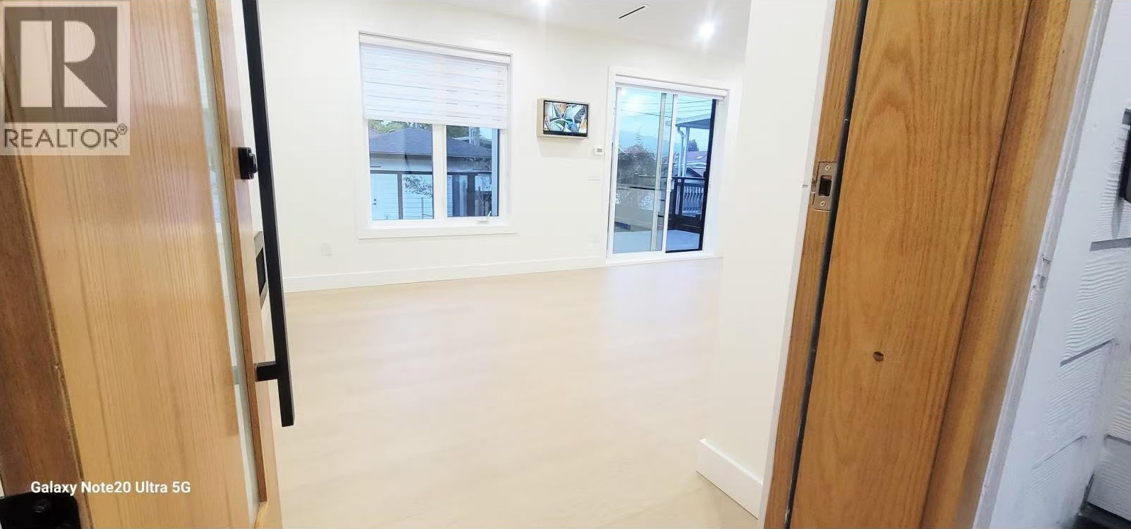 Upper living space seen through the oak entry door