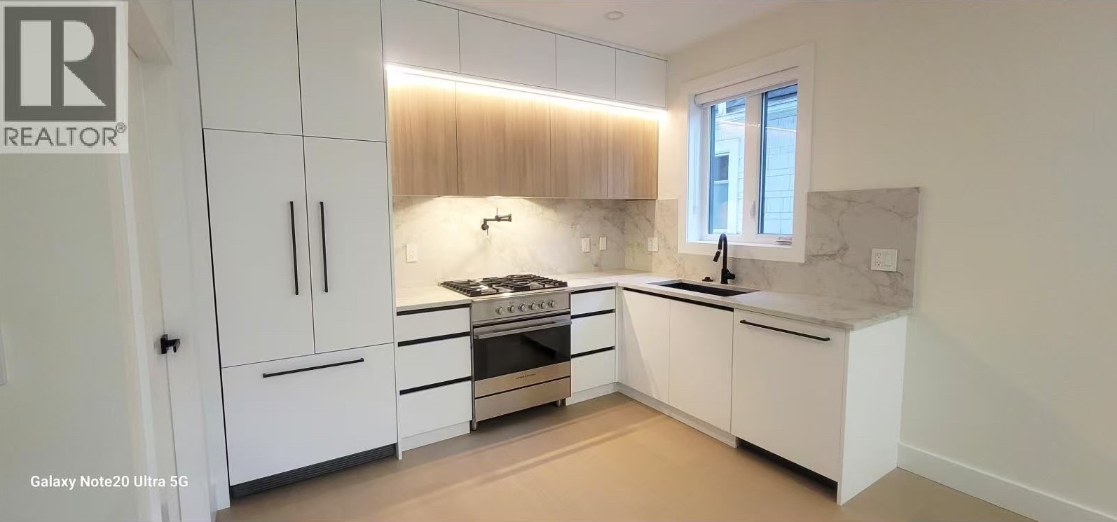 L-shaped kitchen with panel-ready fridge and under-cabinet lighting