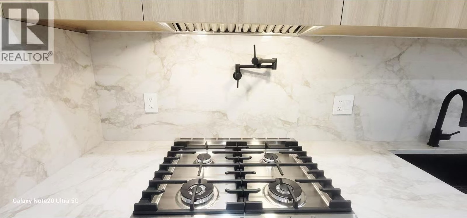 Matte black pot filler over gas cooktop
