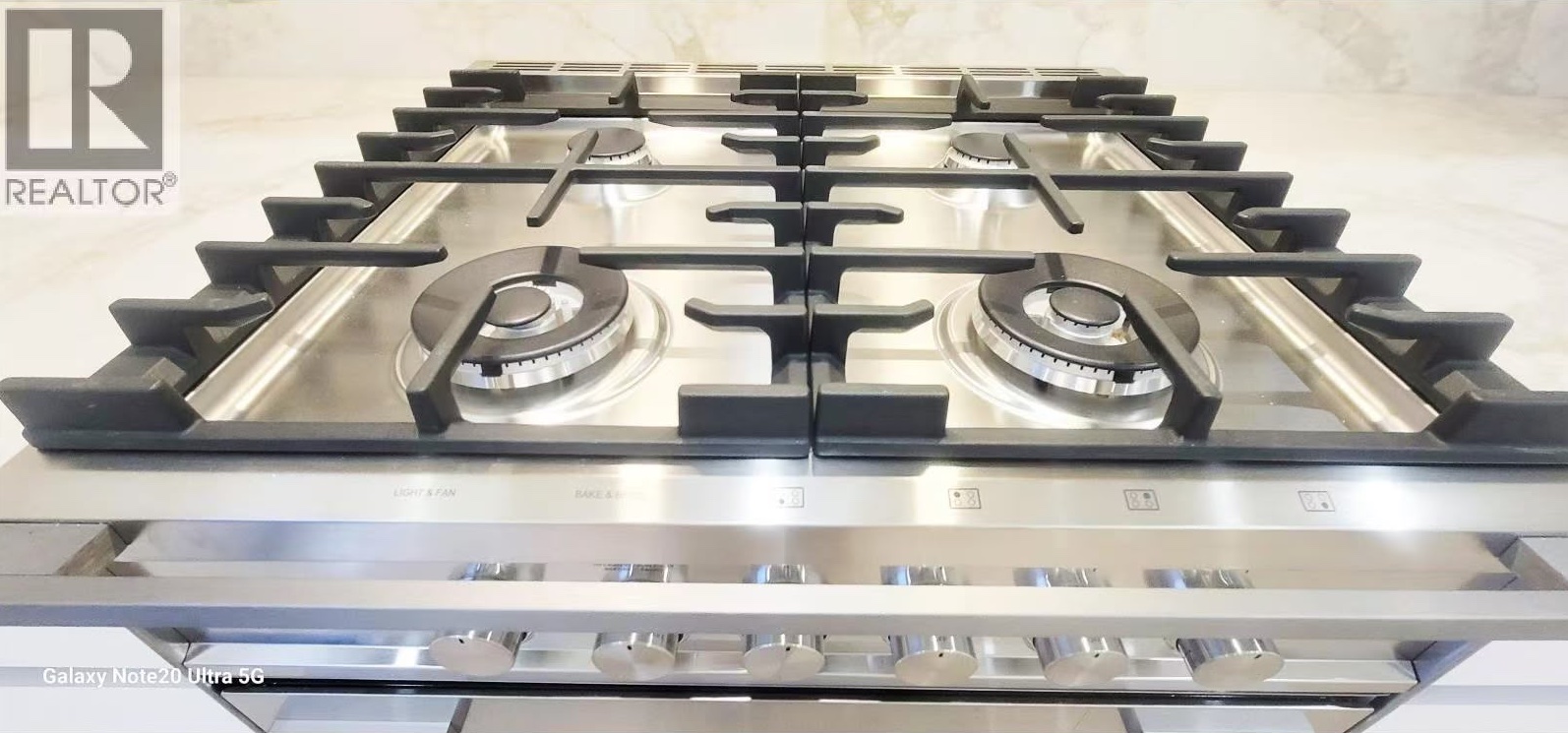 Close-up of five-burner gas cooktop